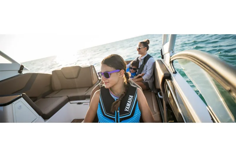 Slide: The Image of 2025 Yamaha Boats 252SE with passengers enjoying a sunny day on the water. - 7
