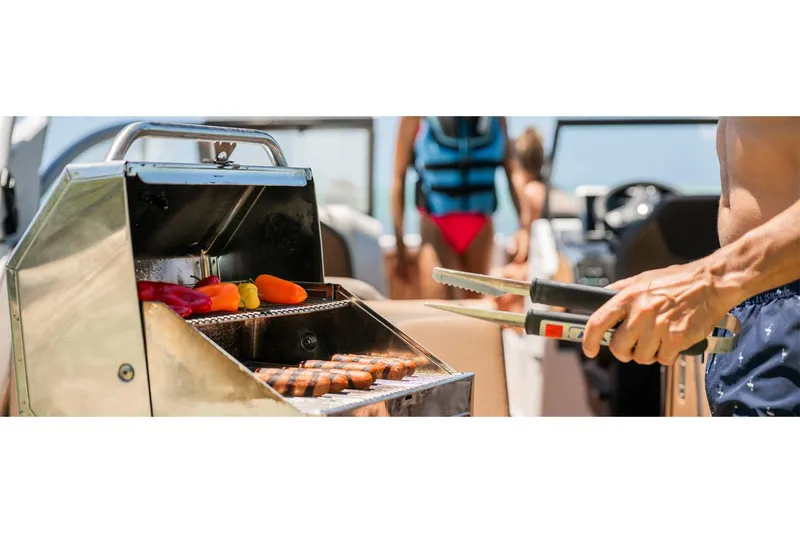 Slide: The Image of Grilling on a 2025 Yamaha Boats 252SE, with colorful vegetables and sausages. - 8