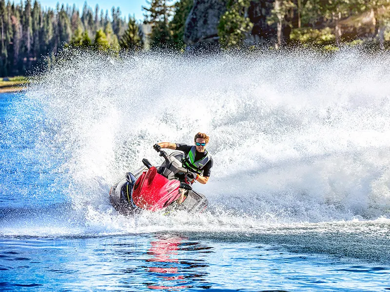 Slide: The Image of 2025 Kawasaki Jet Ski STX 160LX speeding on a lake, creating a large splash. - 13