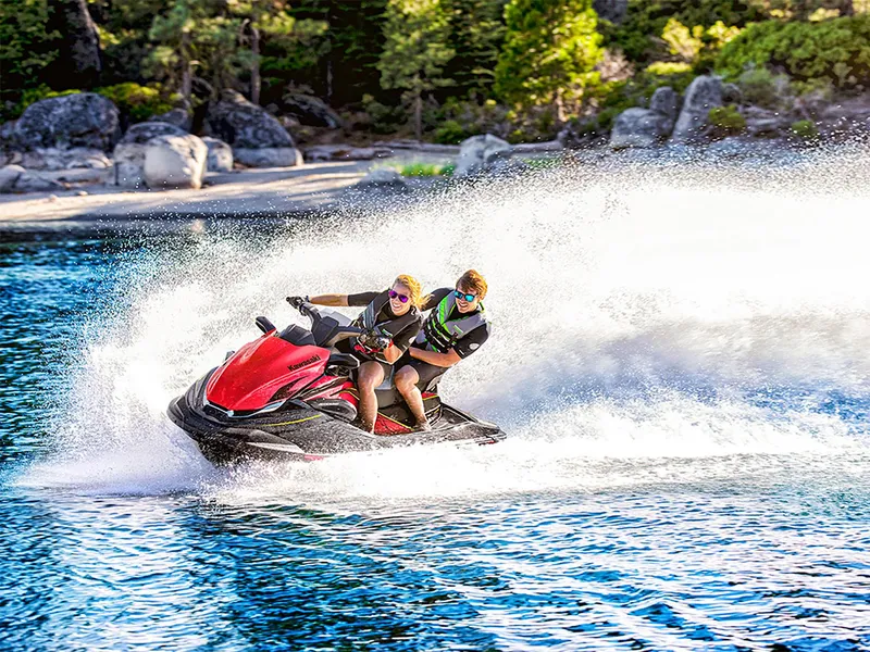 Slide: The Image of 2025 Kawasaki Jet Ski STX 160LX speeding on a scenic lake. - 14