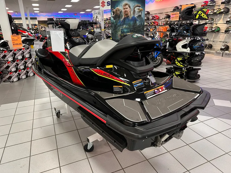 Slide: The Image of 2025 Kawasaki Jet Ski STX 160LX displayed in a showroom with helmets and accessories. - 3