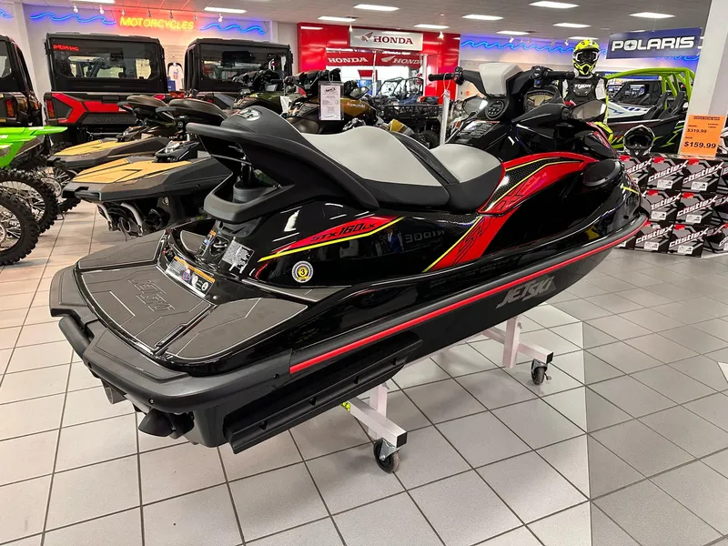 Slide: The Image of 2025 Kawasaki Jet Ski STX 160LX displayed in a showroom with motorcycles and gear. - 4