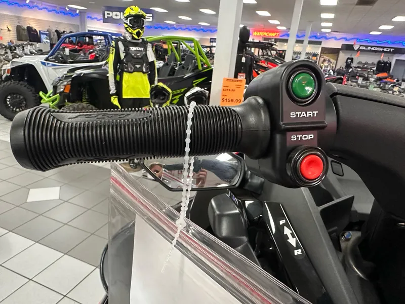 Slide: The Image of Handlebar controls of 2025 Kawasaki Jet Ski STX 160LX in showroom setting. - 6