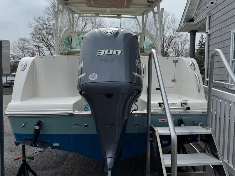 Slide: The Image of 2019 Sailfish 245 DC boat with Yamaha 300 outboard motor, docked with ladder access. - 15
