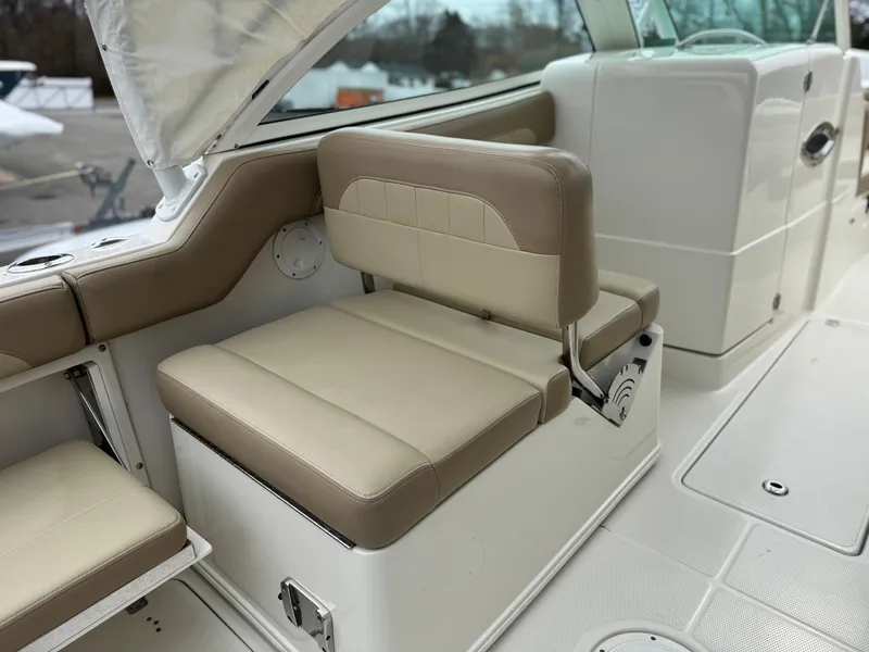 Slide: The Image of 2019 Sailfish 245 DC boat interior with beige seating and white deck. - 8