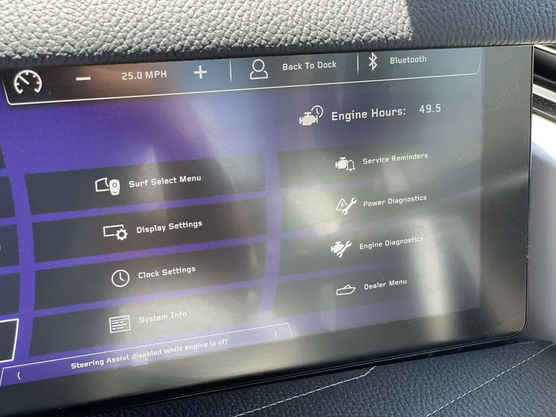 Slide: The Image of 2025 Nautique Super Air Nautique G25 dashboard displaying engine hours and various settings. - 14