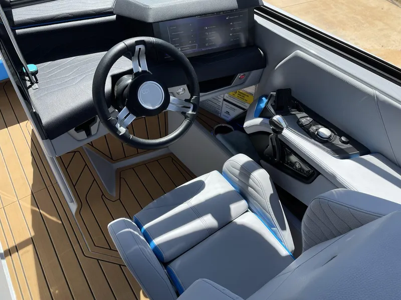 Slide: The Image of 2025 Nautique Super Air Nautique G25 cockpit with modern steering and controls. - 25