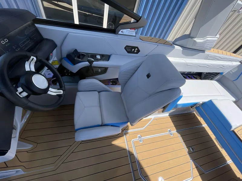 Slide: The Image of 2025 Nautique Super Air Nautique G25 interior with sleek helm and luxurious seating. - 28