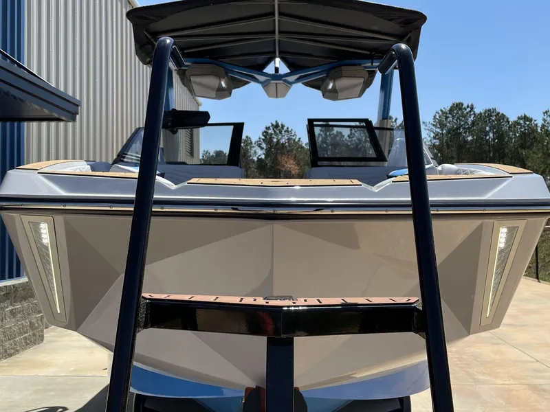 Slide: The Image of 2025 Nautique Super Air Nautique G25 boat, front view, parked outdoors. - 30