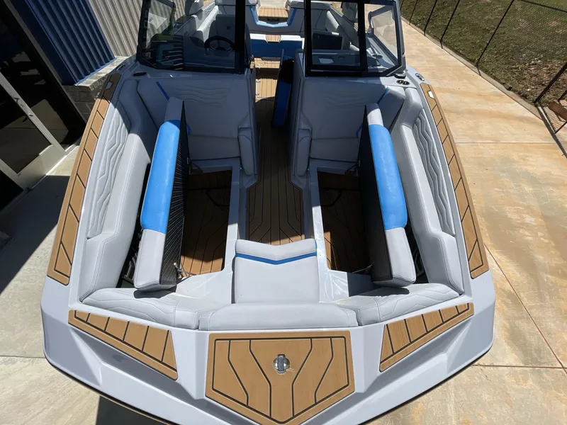 Slide: The Image of 2025 Nautique Super Air Nautique G25 boat interior with blue and gray seating. - 31