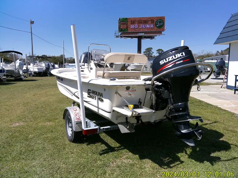 Slide: The Image of 2016 Carolina Skiff JVX16 boat with Suzuki motor on a trailer, parked on grass. - 10