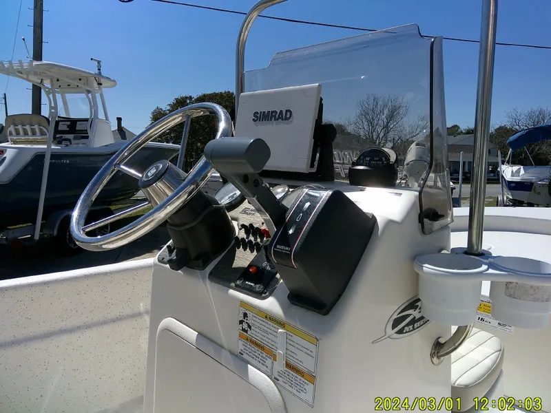 Slide: The Image of 2016 Carolina Skiff JVX16 boat console with steering wheel and Simrad navigation system. - 15