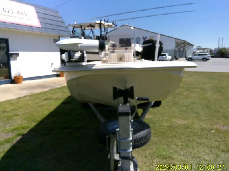 Slide: The Image of 2016 Carolina Skiff JVX16 boat on trailer, parked outside a building on grass. - 3