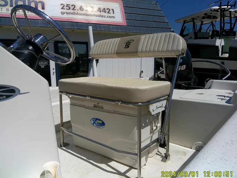 Slide: The Image of 2016 Carolina Skiff JVX16 boat interior with steering wheel and cushioned seat. - 7