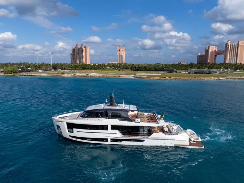 Slide: The Image of Luxurious 2025 Alpha Squalo Co Ownership yacht cruising near coastal resort buildings. - 30