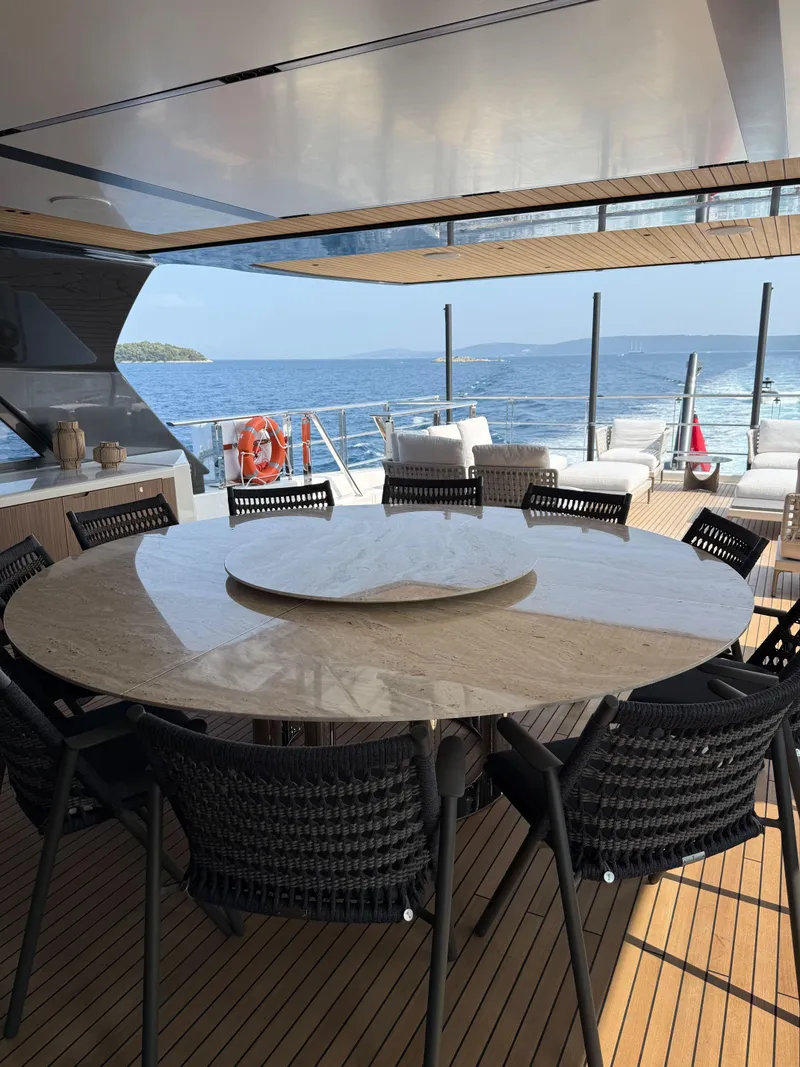 Slide: The Image of Luxury yacht deck with round table, ocean view; Alpha Squalo Co Ownership 2025 model. - 4