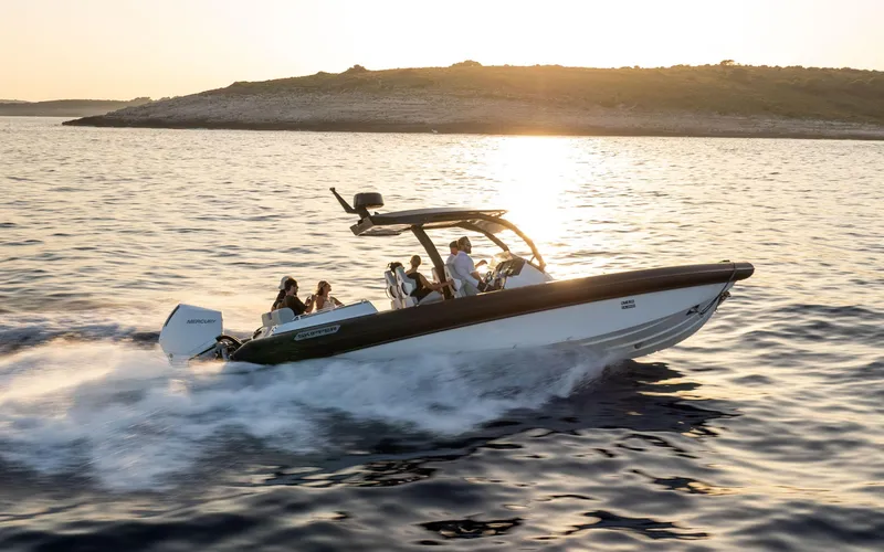 Slide: The Image of 2025 Alpha Squalo Co Ownership boat cruising at sunset on open water. - 9
