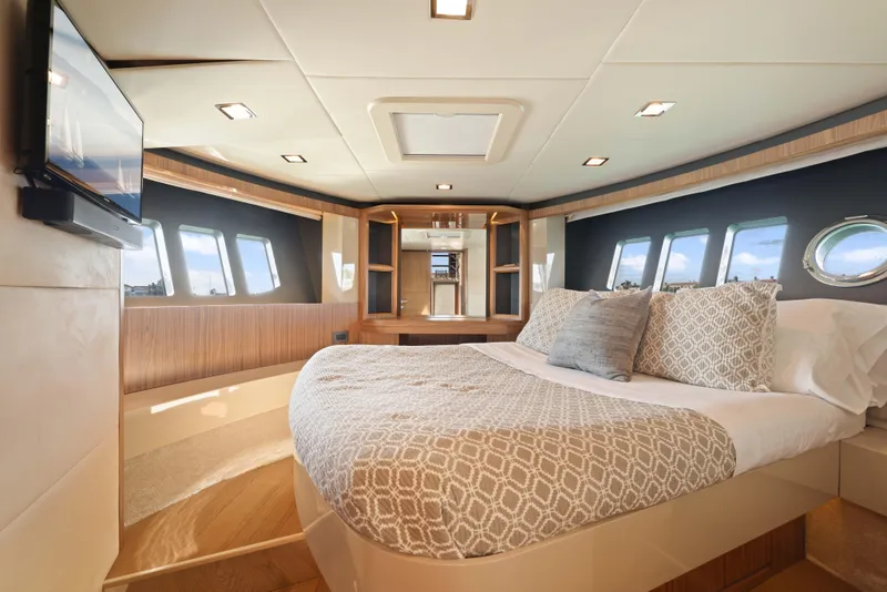 Slide: The Image of Luxurious yacht bedroom interior with modern design, featuring large windows and elegant bedding. - 18
