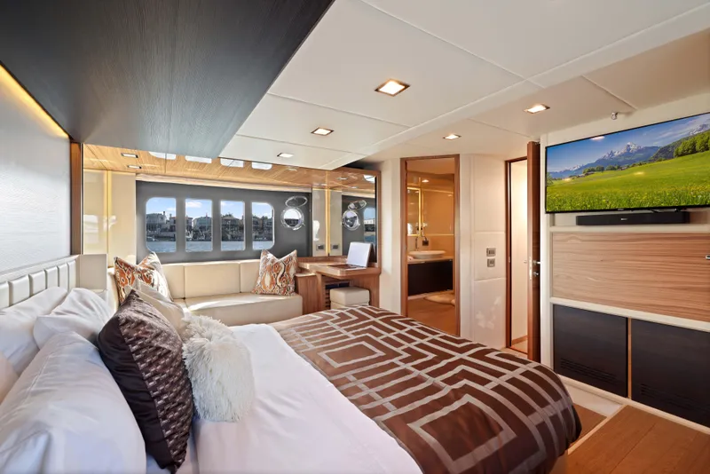 Slide: The Image of Luxurious yacht bedroom with modern decor, large windows, and a wall-mounted TV. Absolute Fly Co Ownership 2015. - 29