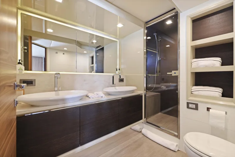Slide: The Image of Luxurious yacht bathroom with dual sinks, modern shower, and elegant shelving. - 34