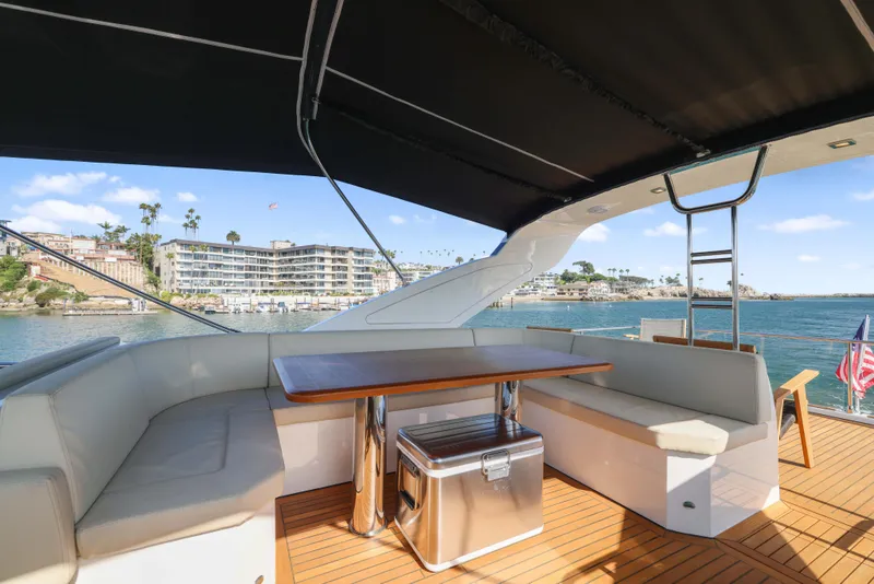 Slide: The Image of Luxurious yacht deck with seating, table, and ocean view; Absolute Fly Co Ownership, 2015 model. - 48