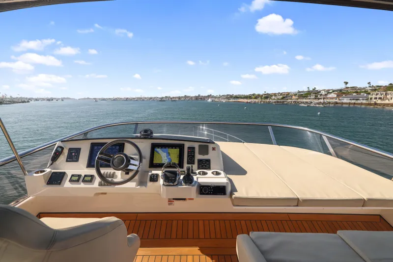 Slide: The Image of Helm of 2015 Absolute Fly Co Ownership yacht with ocean view and clear sky. - 50