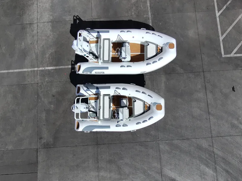 Slide: The Image of Two 2025 Tide Craft San Juan 11 boats parked on a concrete surface, aerial view. - 7