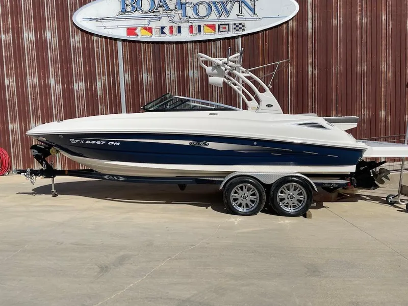 Slide: The Image of 2016 Sea Ray 240 Sundeck boat on trailer, parked outside Boat Town. - 0