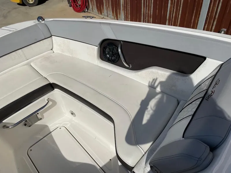 Slide: The Image of Interior of 2016 Sea Ray 240 Sundeck boat with white seating and speaker. - 13
