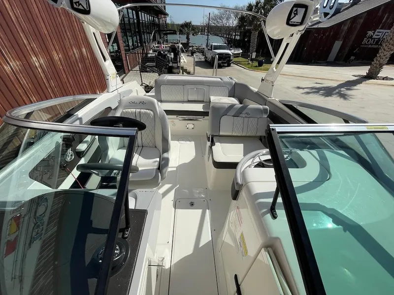Slide: The Image of 2016 Sea Ray 240 Sundeck boat interior with seating and steering wheel. - 15