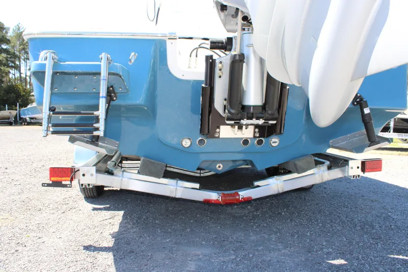 Slide: The Image of 2025 Tidewater 2500 Carolina Bay boat on trailer, rear view with motor and ladder. - 19