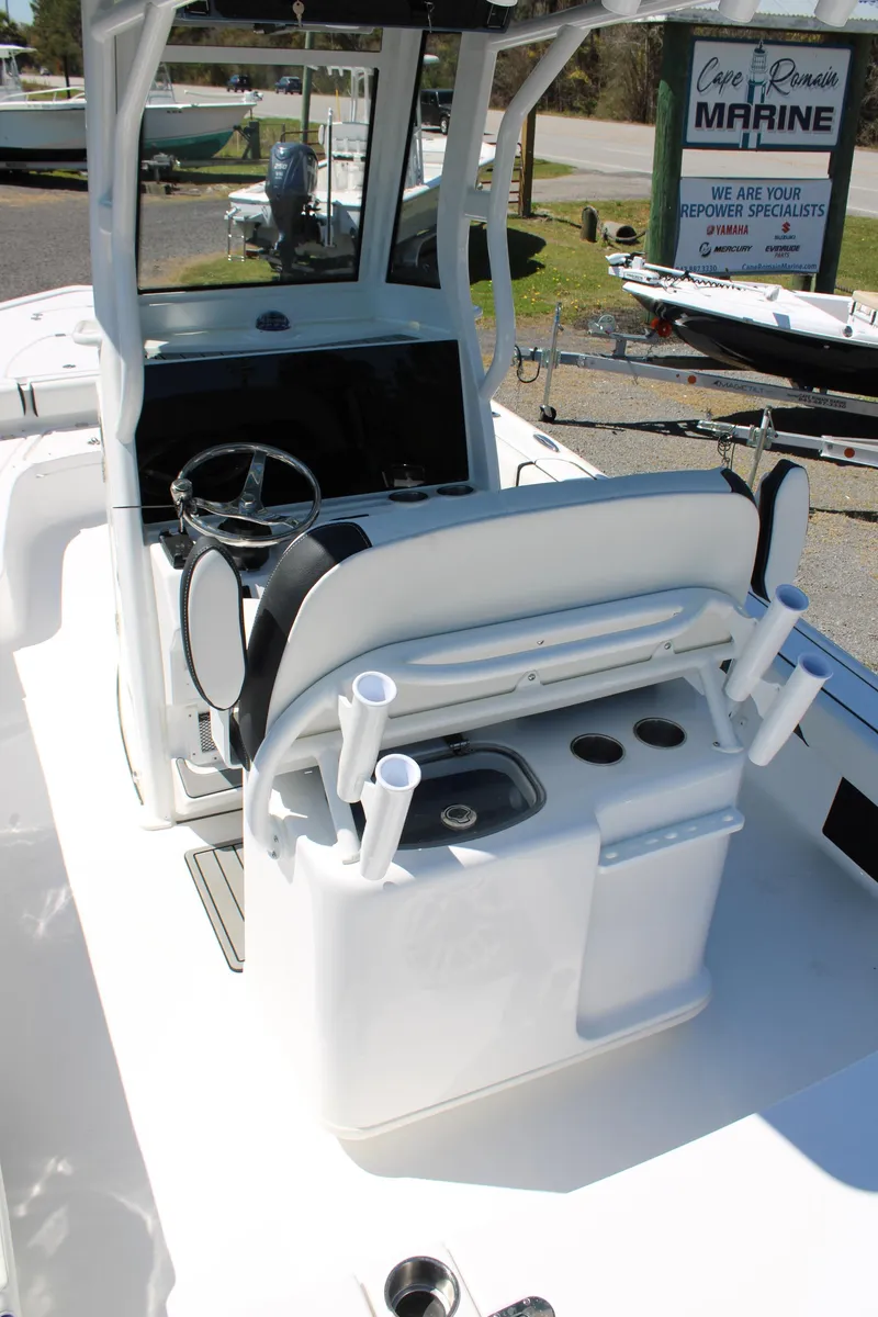 Slide: The Image of 2025 Tidewater 2500 Carolina Bay boat interior with steering console and rod holders. - 20
