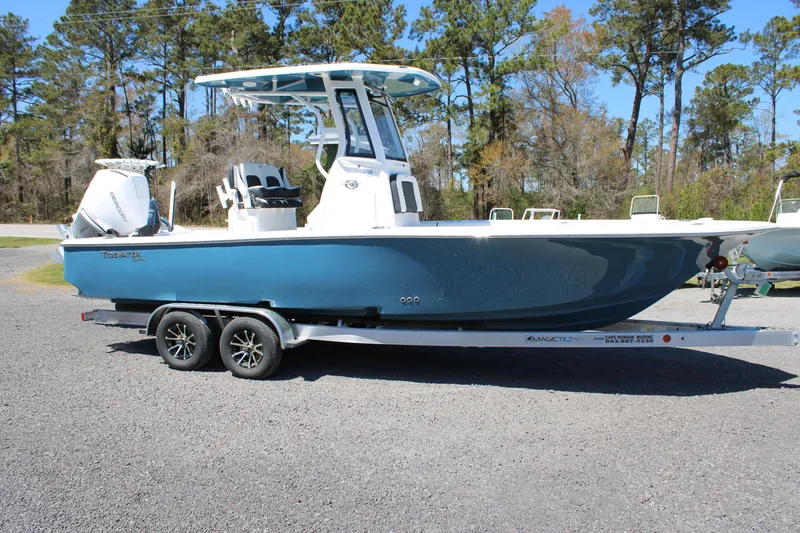 Slide: The Image of 2025 Tidewater 2500 Carolina Bay boat on trailer, parked outdoors. - 27