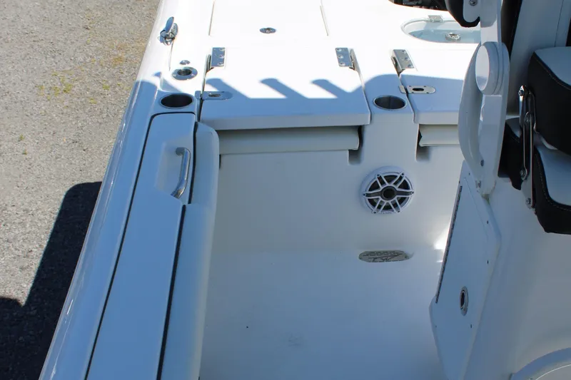 Slide: The Image of 2025 Tidewater 2500 Carolina Bay boat interior with storage compartments and speaker. - 31
