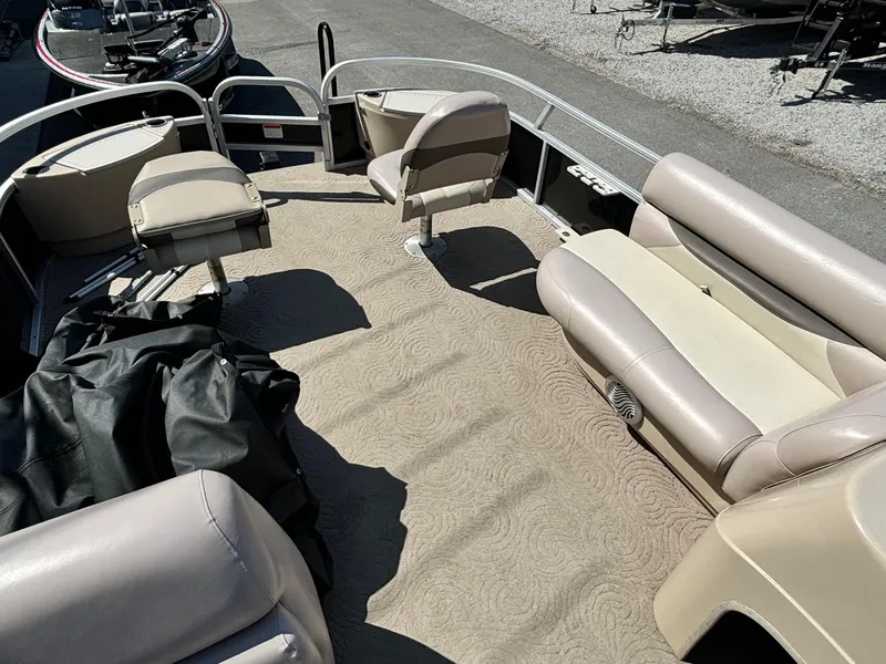 Slide: The Image of 2014 Sun Tracker Fishin' Barge 24 DLX interior with beige seating and carpet. - 3