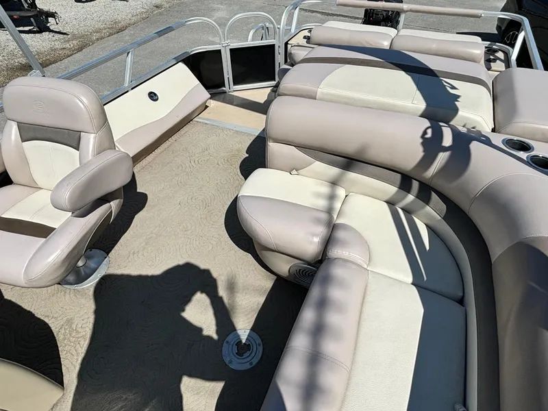 Slide: The Image of 2014 Sun Tracker Fishin' Barge 24 DLX interior with beige seating and spacious layout. - 5