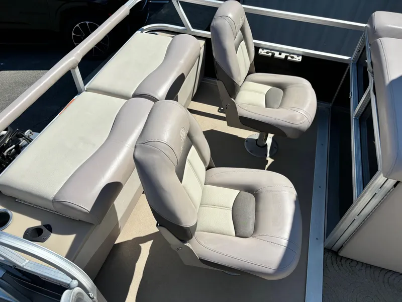 Slide: The Image of 2014 Sun Tracker Fishin' Barge 24 DLX interior with cushioned seating and fishing chairs. - 6