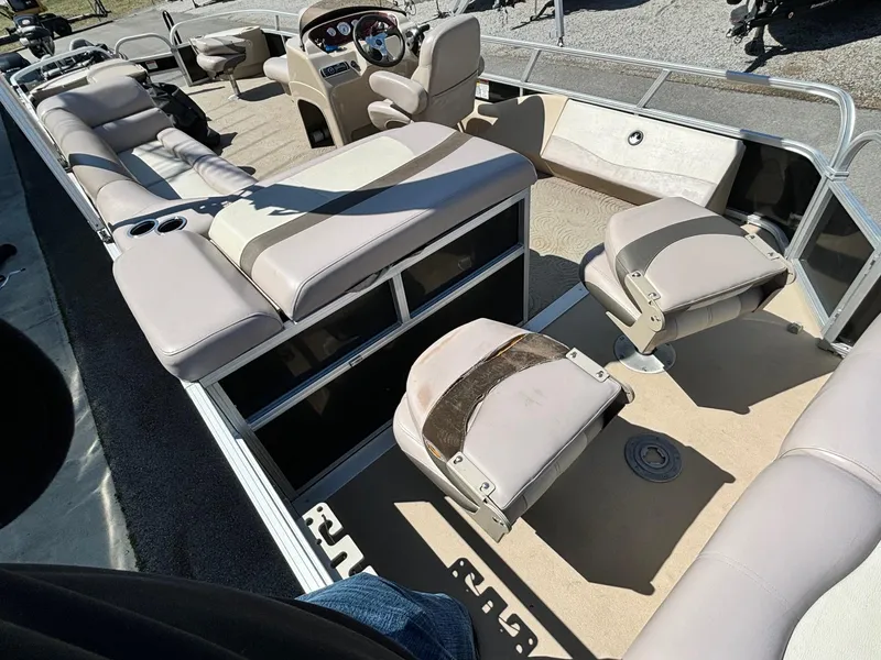 Slide: The Image of 2014 Sun Tracker Fishin' Barge 24 DLX interior with beige seating and steering console. - 7