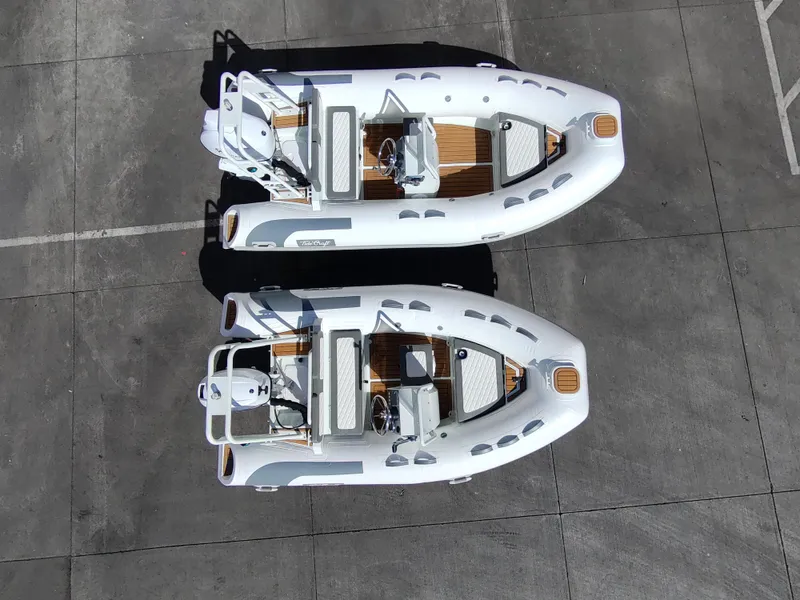 Slide: The Image of Two 2025 Tide Craft Catalina 13 boats on concrete surface, aerial view. - 10
