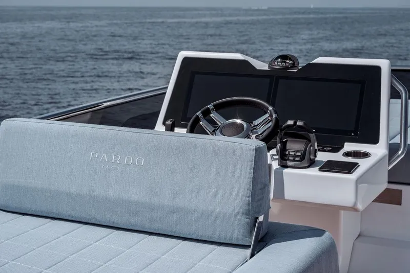Slide: The Image of 2023 Pardo Yachts Endurance 60 helm with ocean backdrop, featuring modern controls and seating. - 18