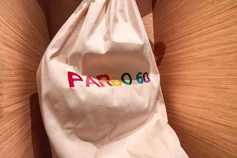 Slide: The Image of Cloth bag with colorful "PARDO 60" text, inside a wooden interior. - 25
