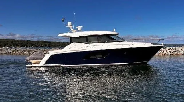 Slide: The Image of 2019 Tiara Yachts 490 Coupe on water, sleek design, blue and white exterior. - 0