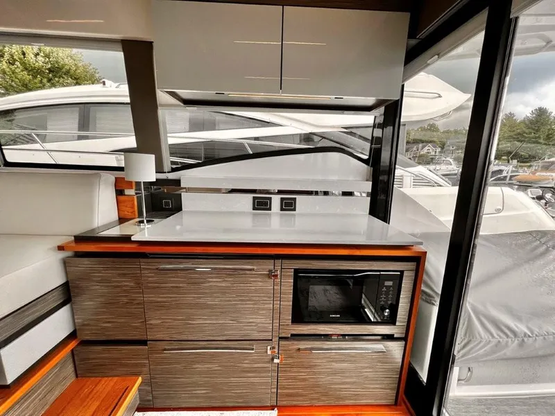 Slide: The Image of Modern interior of 2019 Tiara Yachts 490 Coupe with sleek cabinetry and microwave. - 11