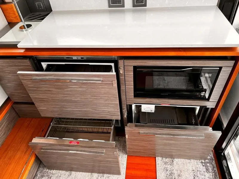 Slide: The Image of Modern kitchen area in 2019 Tiara Yachts 490 Coupe with open drawers and appliances. - 12