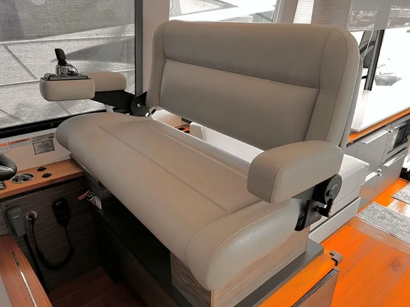 Slide: The Image of Captain's seat in 2019 Tiara Yachts 490 Coupe, featuring modern design and controls. - 13
