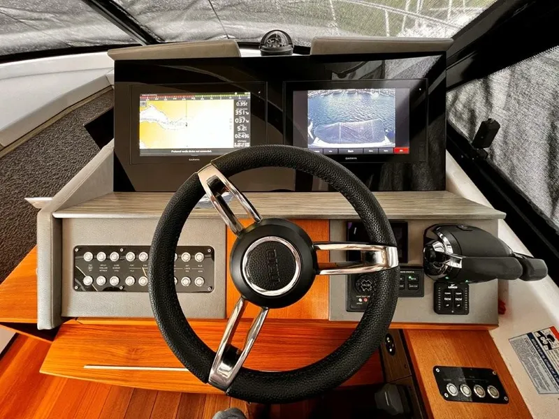 Slide: The Image of 2019 Tiara Yachts 490 Coupe helm with navigation screens and controls. - 14