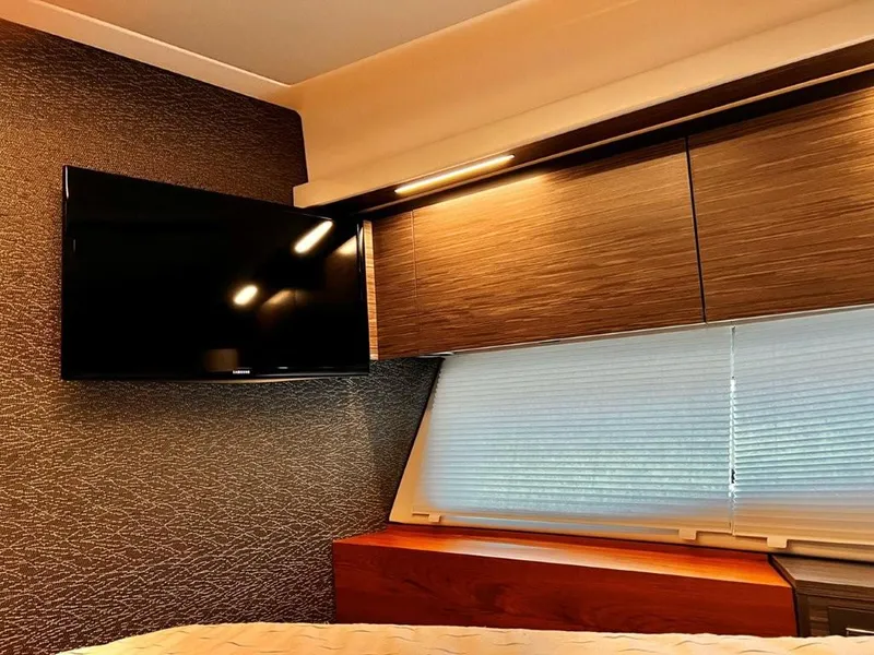 Slide: The Image of Interior of 2019 Tiara Yachts 490 Coupe with TV and wooden cabinetry. - 18