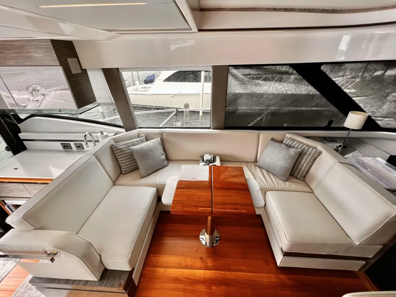 Slide: The Image of Luxurious interior of 2019 Tiara Yachts 490 Coupe with elegant seating and wooden table. - 2