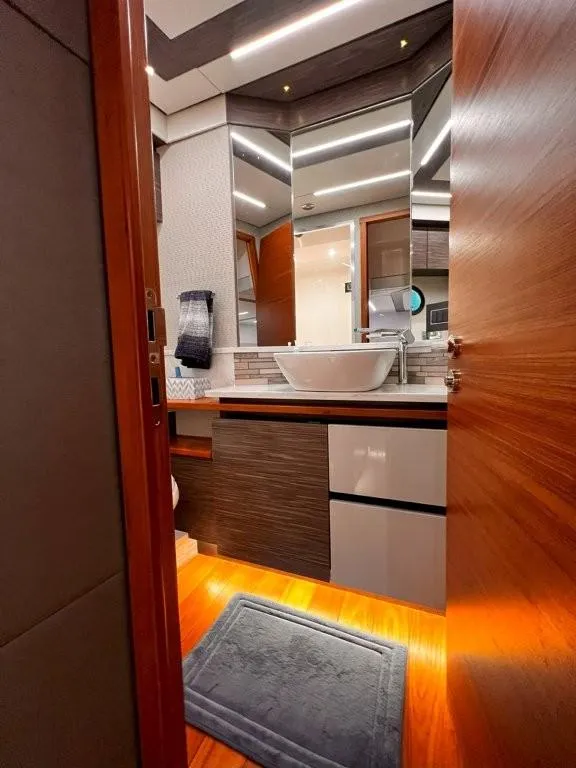 Slide: The Image of Luxurious bathroom interior of 2019 Tiara Yachts 490 Coupe with modern fixtures and wood accents. - 23