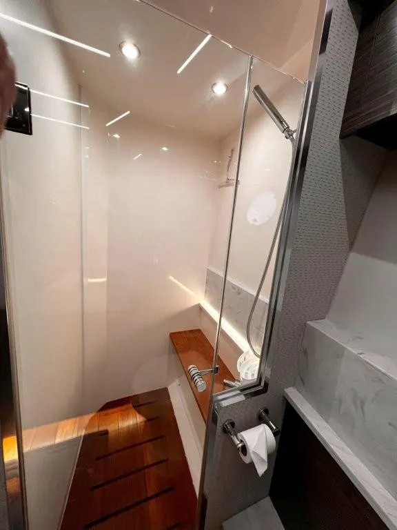 Slide: The Image of Luxurious shower area in 2019 Tiara Yachts 490 Coupe with modern fixtures and wooden accents. - 25